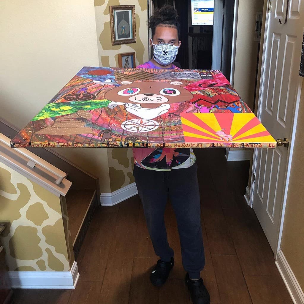 Side angle view of Kanye art canvas showing depth, painted edges, and text